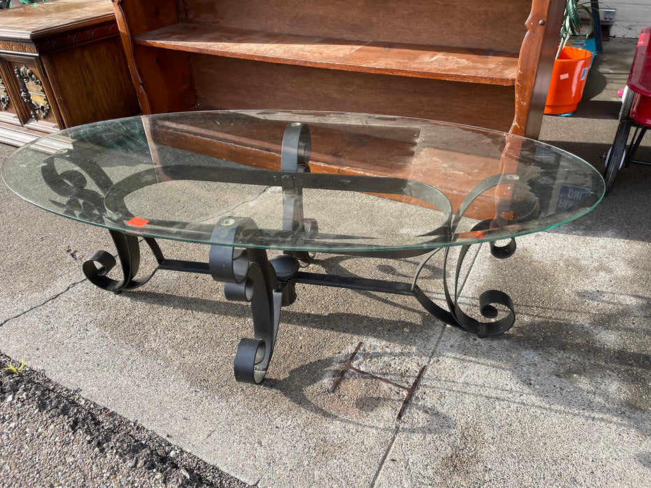 Beveled glass coffee table with ornate metal base 31930