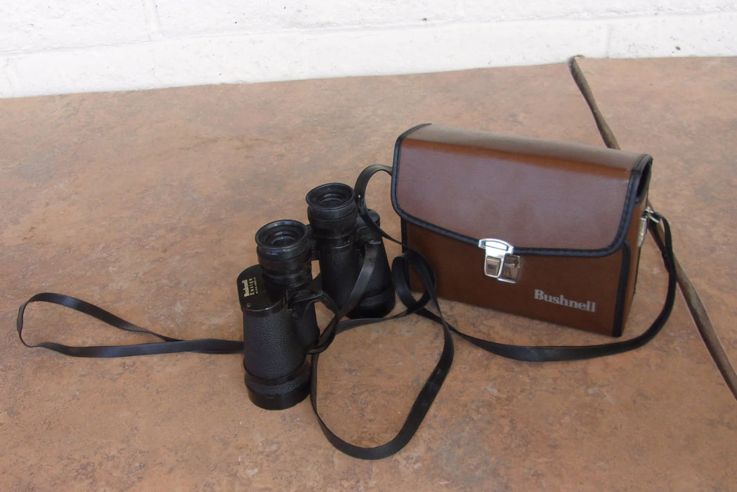 Bushnell binoculars with leather case 16868